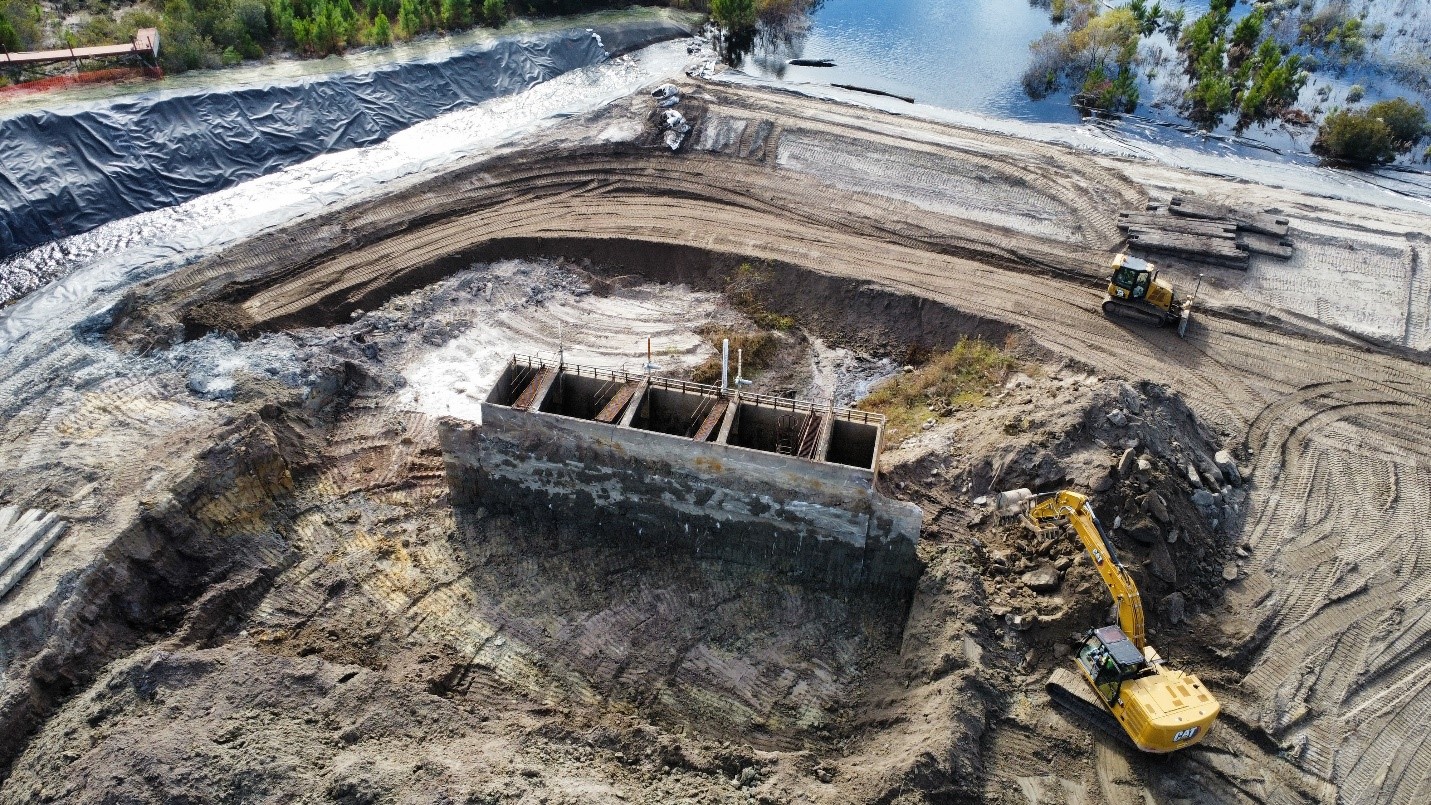 Excavation around the spillway.  2nd MIP drill mobilization